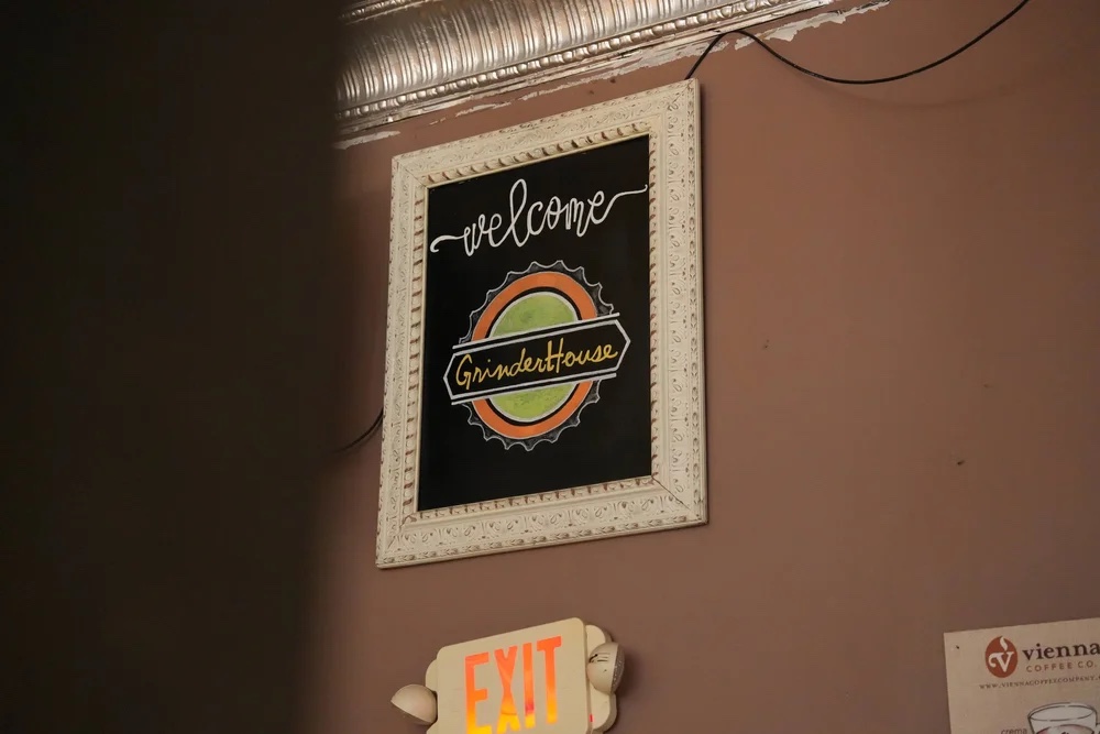 GrinderHouse Coffee wall sign inside the downtown coffee shop